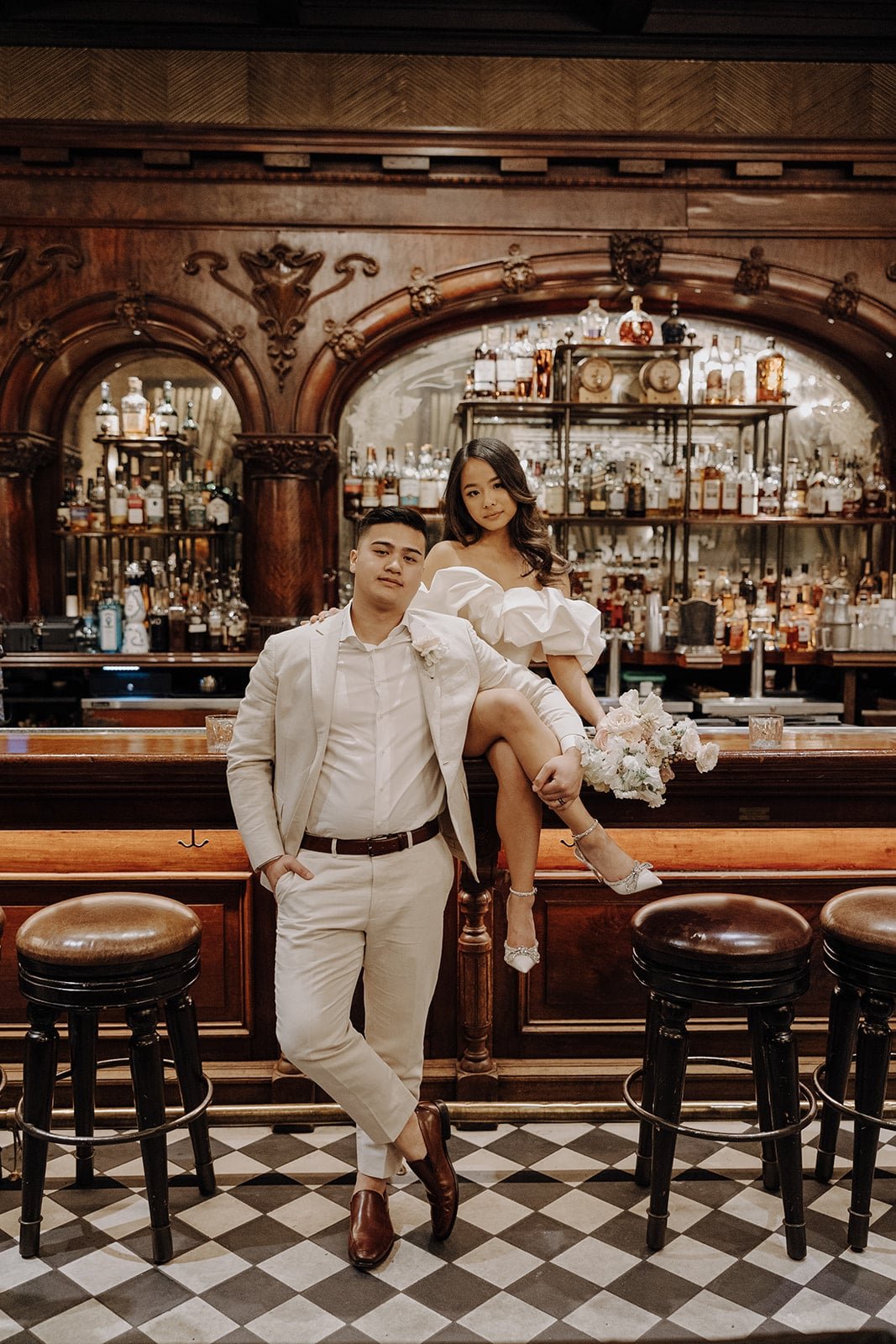 Bride and groom sit at a speakeasy bar during their Las Vegas elopement photos at the Cosmopolitan