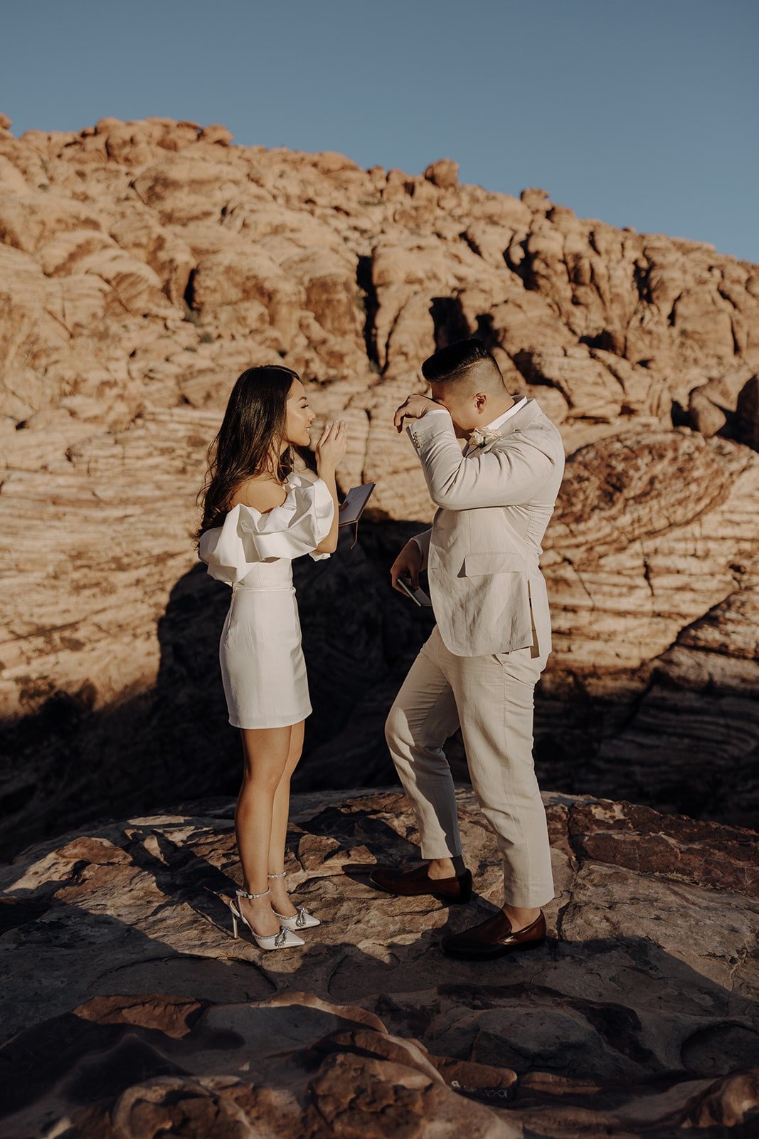 Bride and groom get emotional while reading personal vows at their Las Vegas elopement in Red Rock Canyon