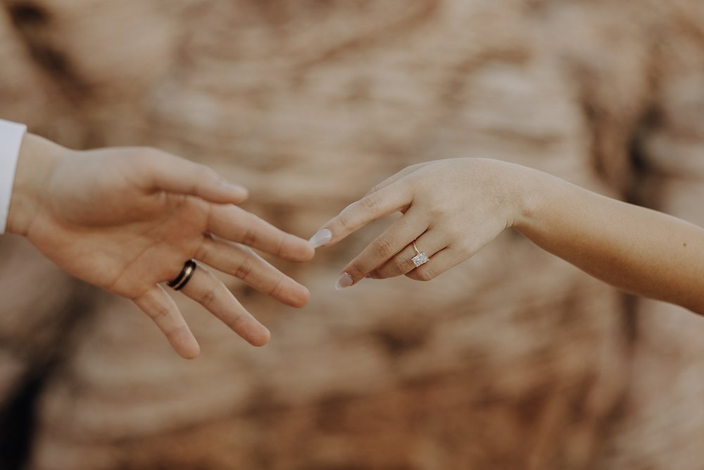 Bride and groom hold hands during their elopement photos at Red Rock Canyon