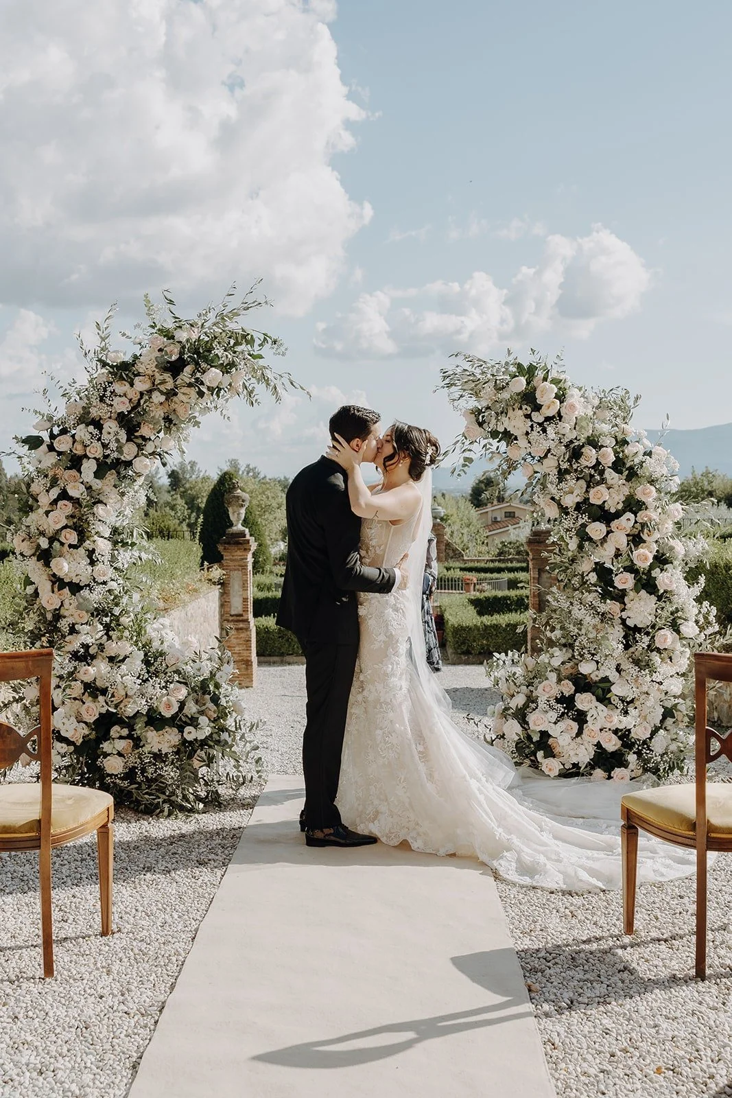 Bride and groom kiss during their Italian villa wedding ceremony