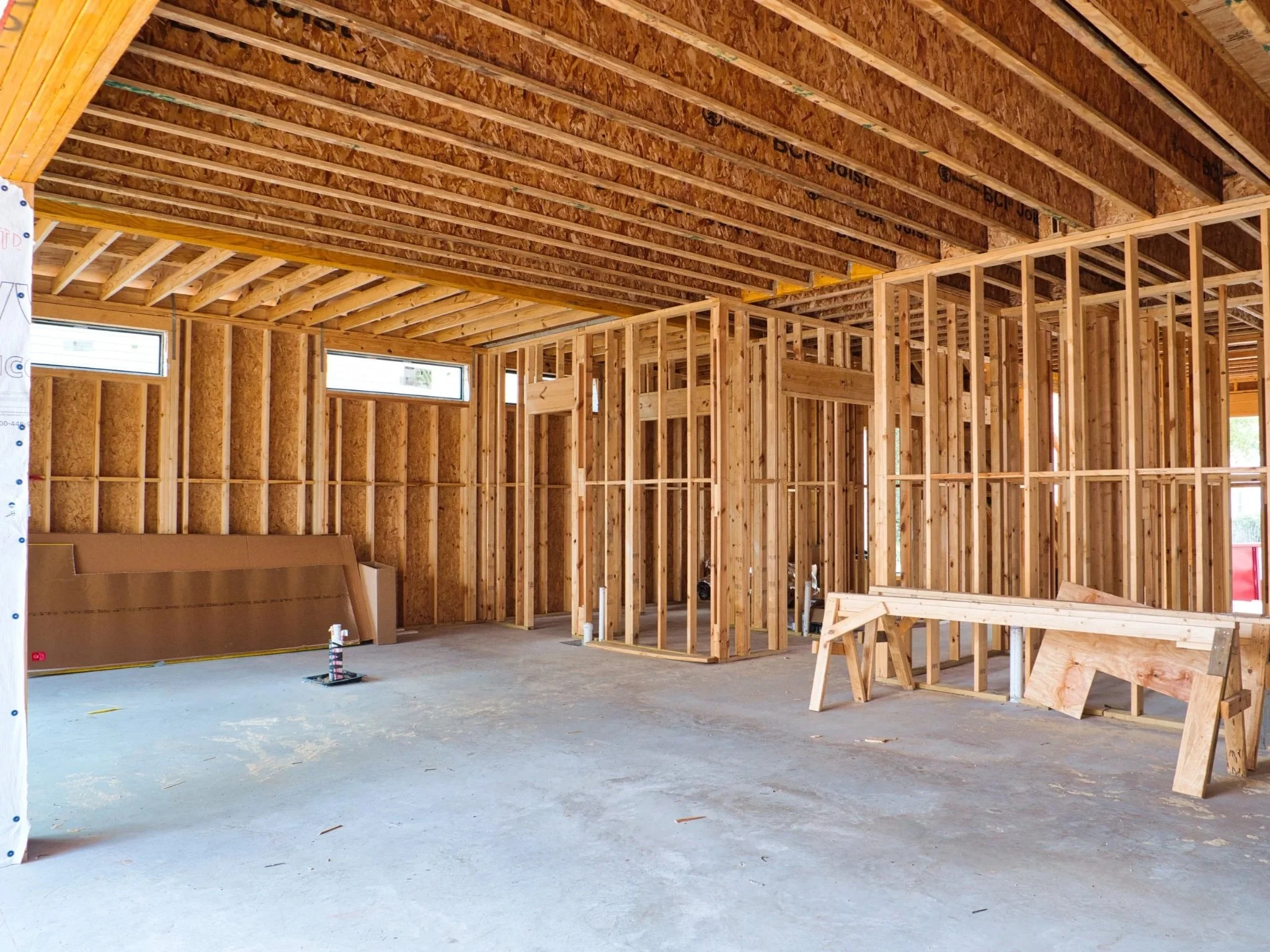 Open interior framing with wall studs and floor system during residential renovation