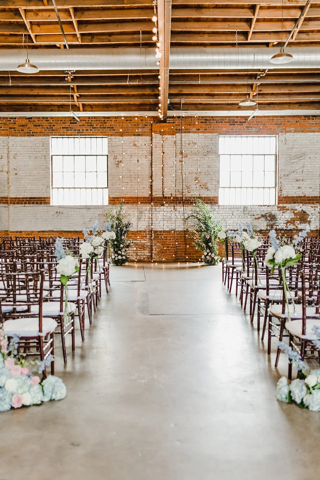 Industrial-chic wedding venue at Studio 215 near Fort Bragg, NC, featuring a luxury bridal suite, exposed brick walls, and modern warehouse charm for ceremonies and receptions.