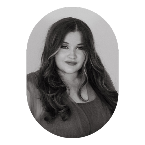 Black and white portrait of a woman with long, wavy hair, smiling slightly, against a plain background with an oval border.