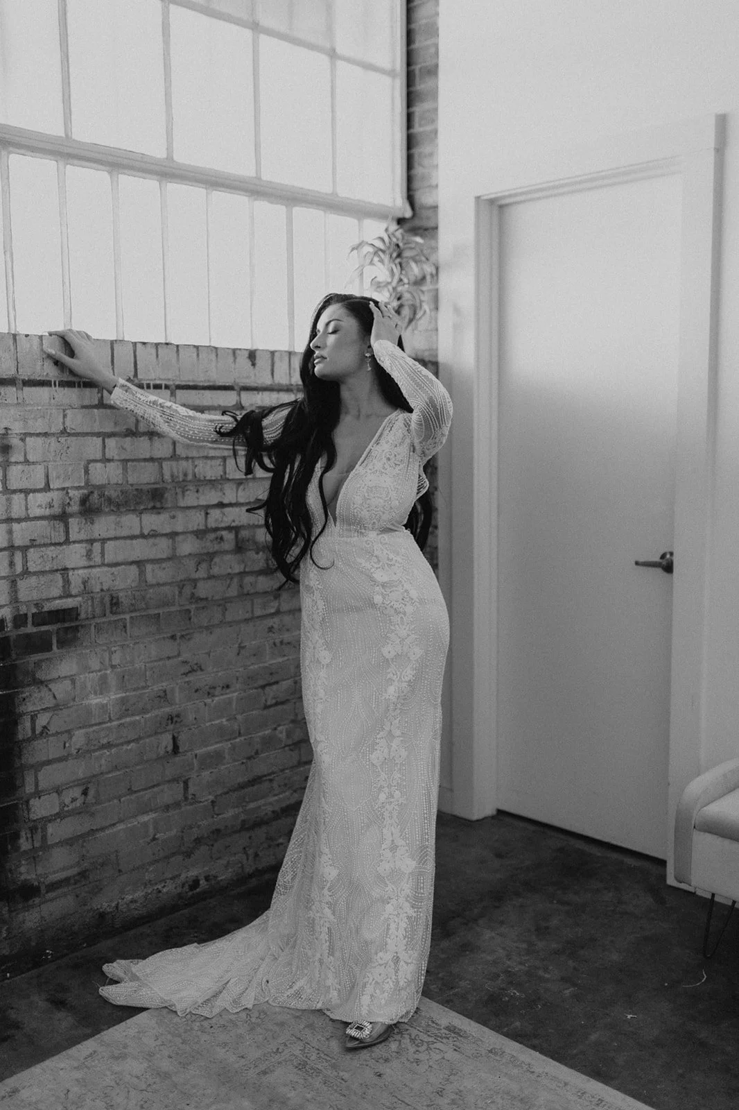 Industrial warehouse wedding venue at Studio 215 in Fayetteville, NC, located near Raleigh and Fort Bragg, featuring exposed brick, bistro lighting, and a modern chic aesthetic for weddings and events. 