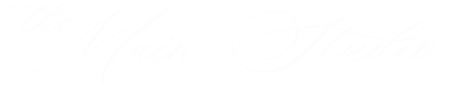 Stylized text that says 'The Main Studio' in white cursive font on a black background.