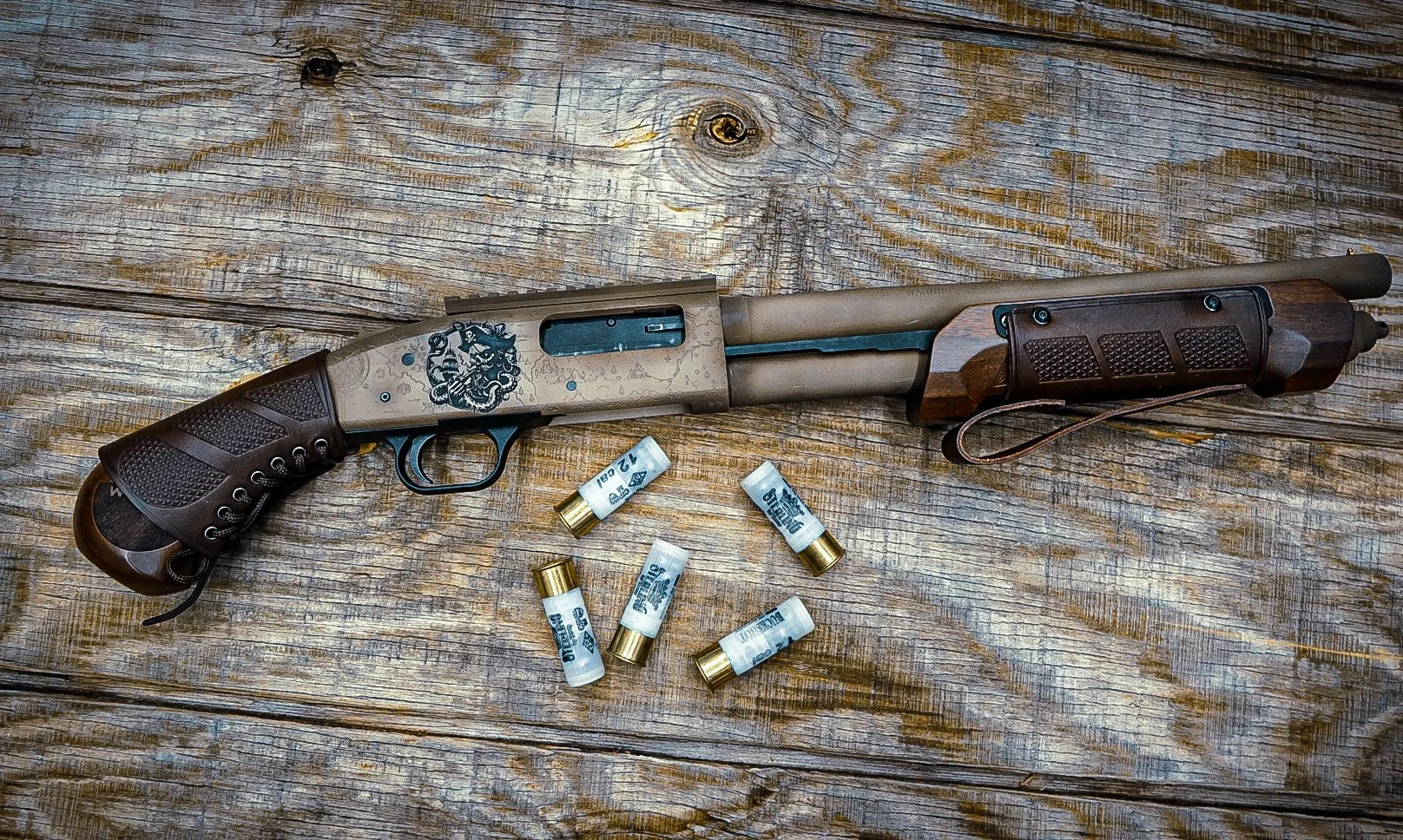 A shotgun with a decorative tiger head on the stock, lying on a weathered wooden surface with five shotgun shells nearby.