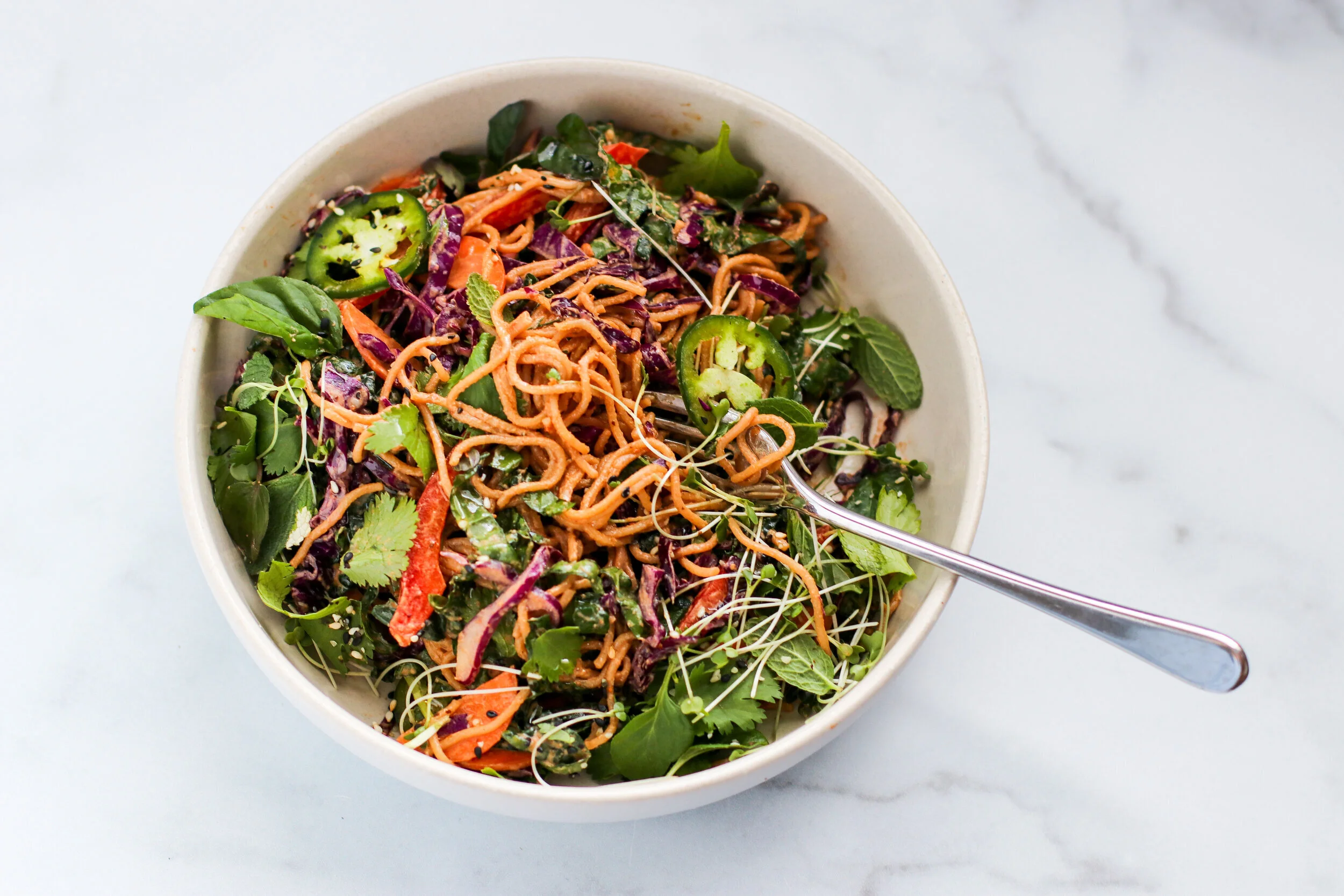 spicy sesame noodle salad with cabbage and lime