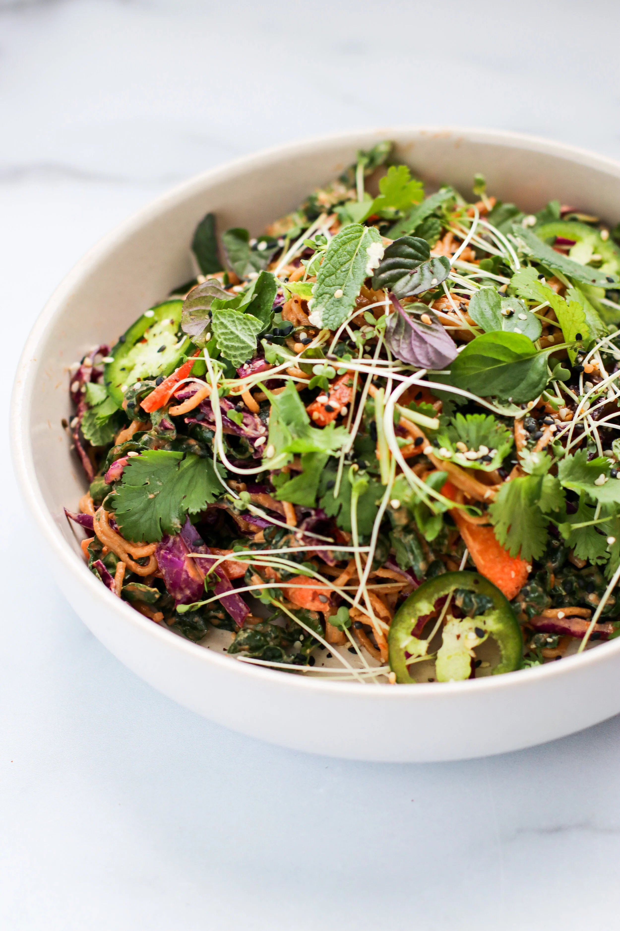 spicy thai noodle salad with sesame, cabbage, and lime