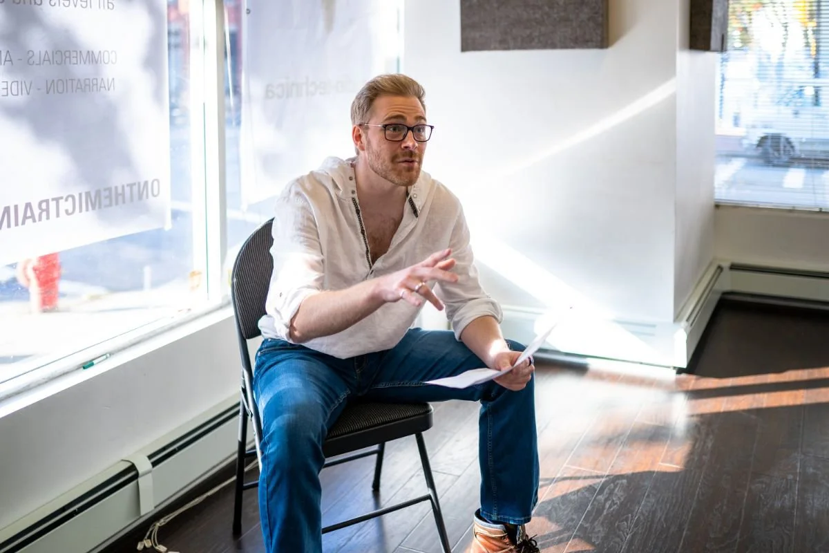 Instructor seated and speaking during a marketing workshop
