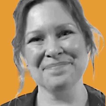 Erin Mathews smiling in a black-and-white headshot against a gold background.