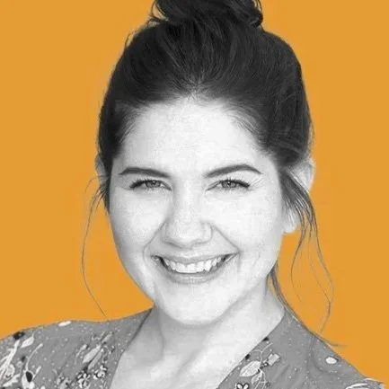 Krystal Meadows smiling in a black-and-white headshot against a gold background.