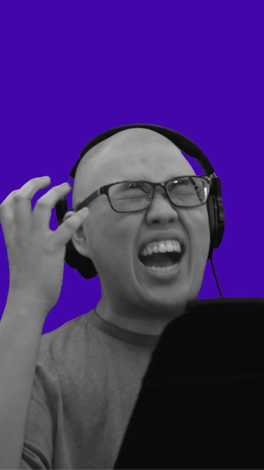 Voice-over student wearing headphones delivering an expressive performance during a studio recording session.