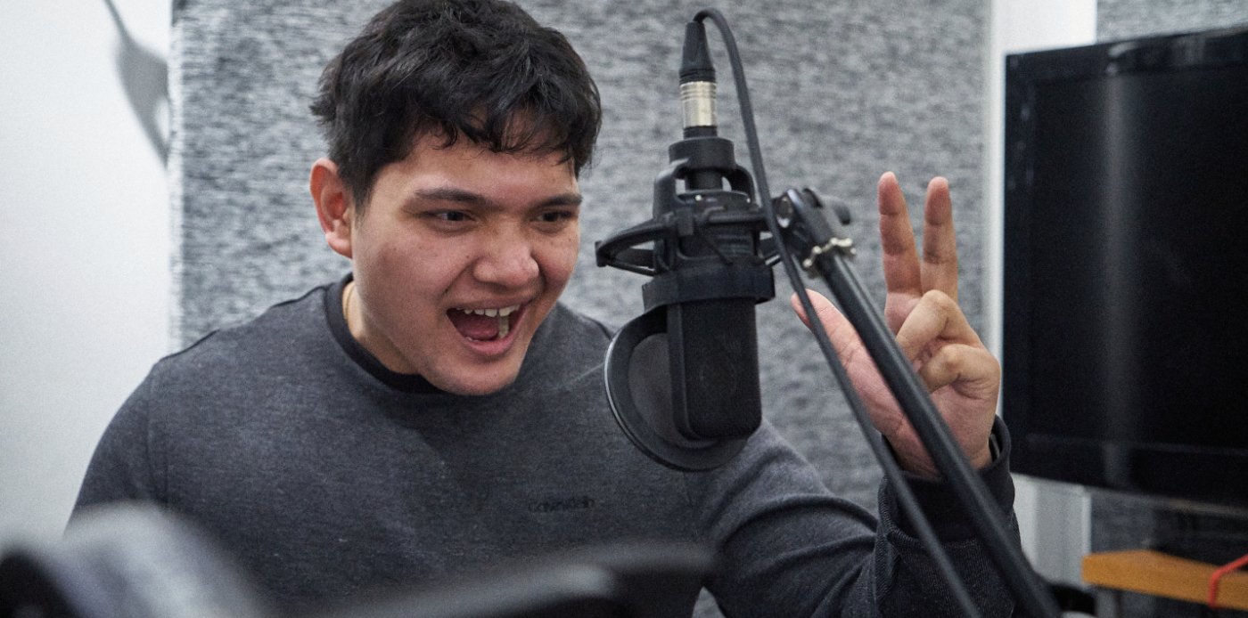 Man speaking into a studio microphone during a Commercial Voice-Over Level 1 class