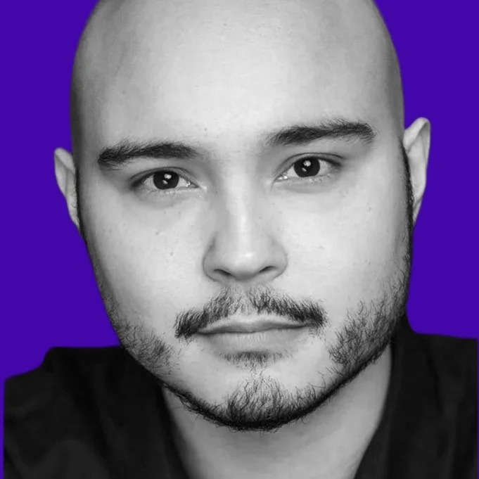 Brian Doe Chua facing the camera in a black-and-white headshot against a gold background.