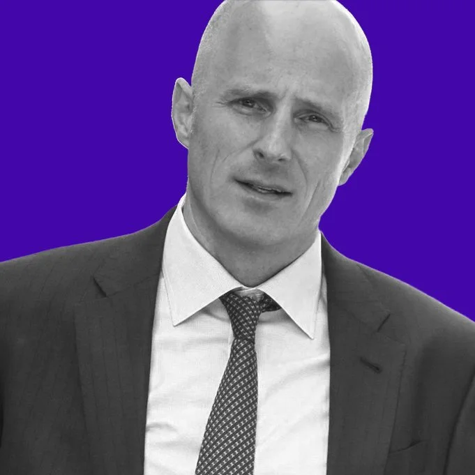 Michael Daingerfield in a black-and-white headshot against a purple background.