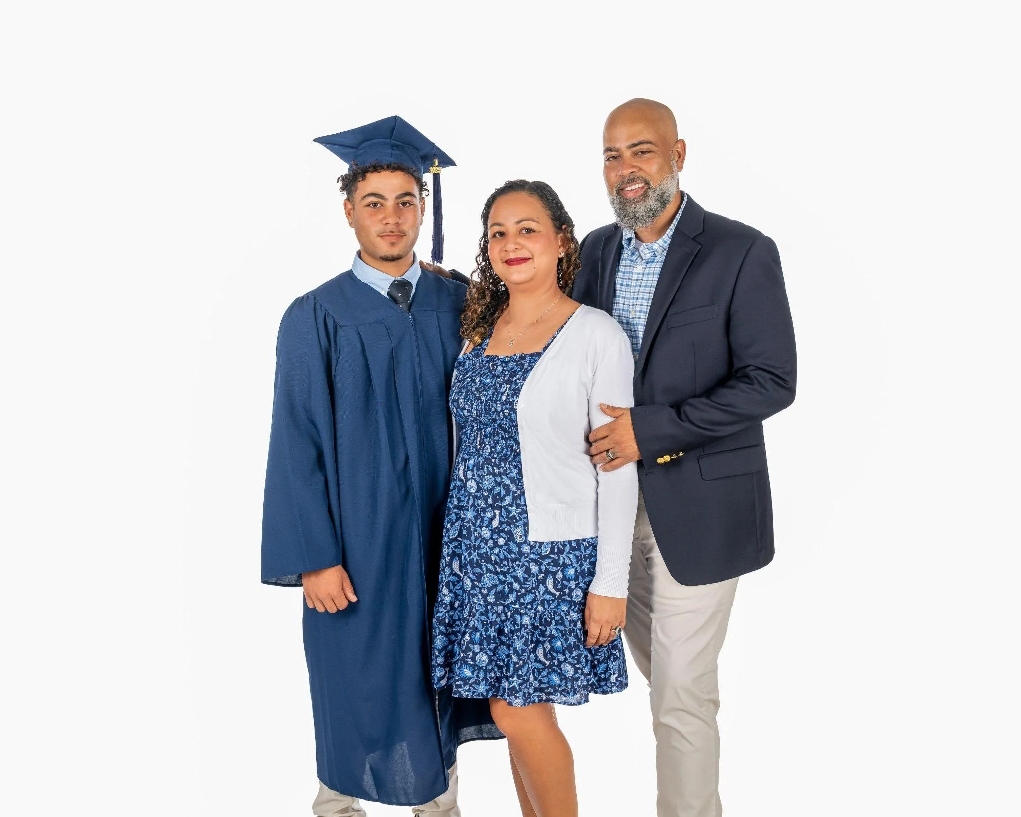 Family with graduate in blue gown posing together.