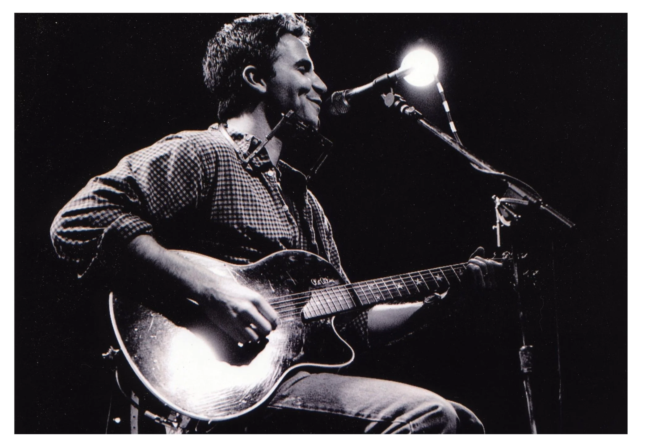 Martin Zellar black and white playing guitar and singing onstage