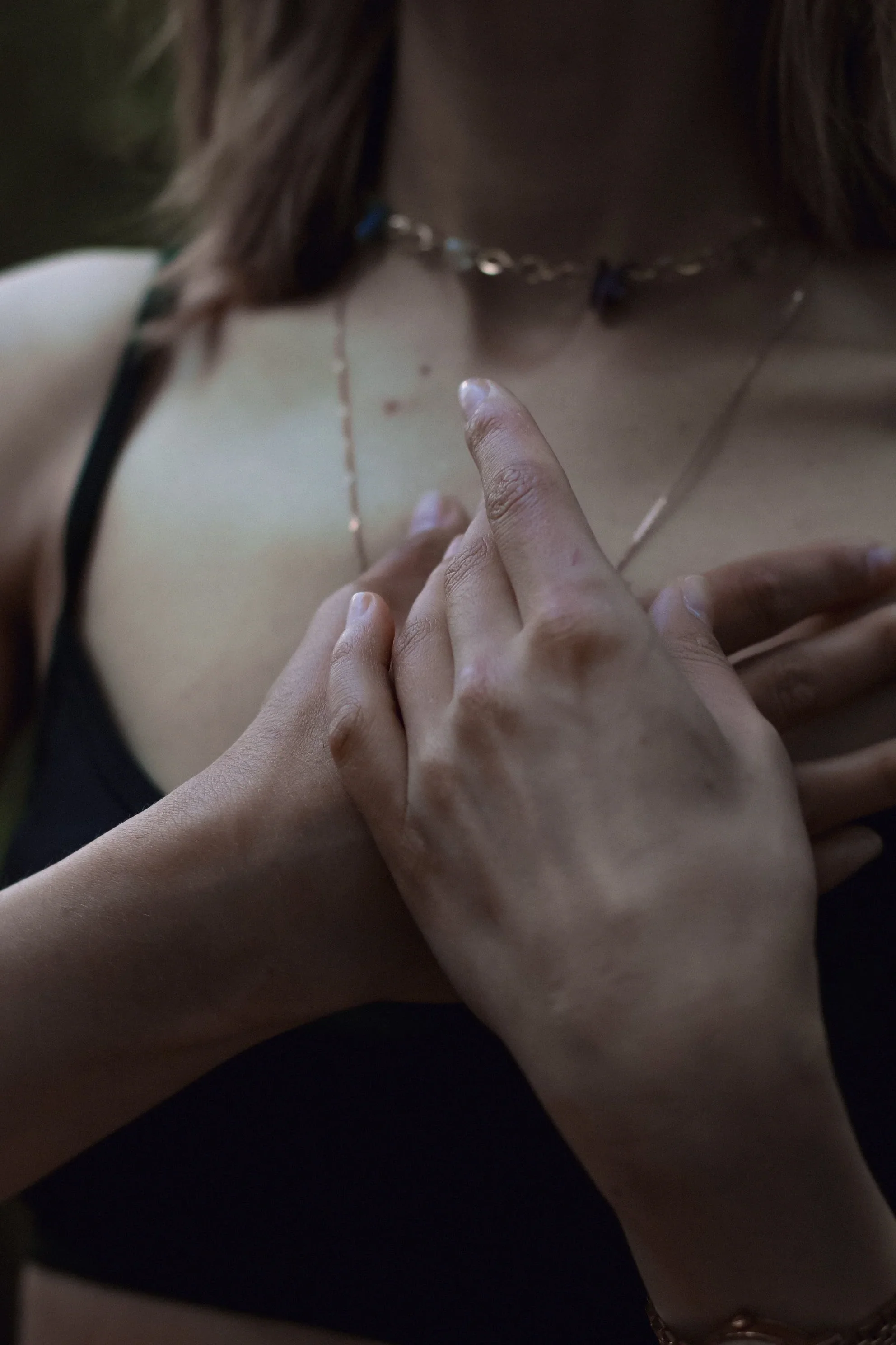 Woman practicing somatic grounding to reconnect with their body after trauma