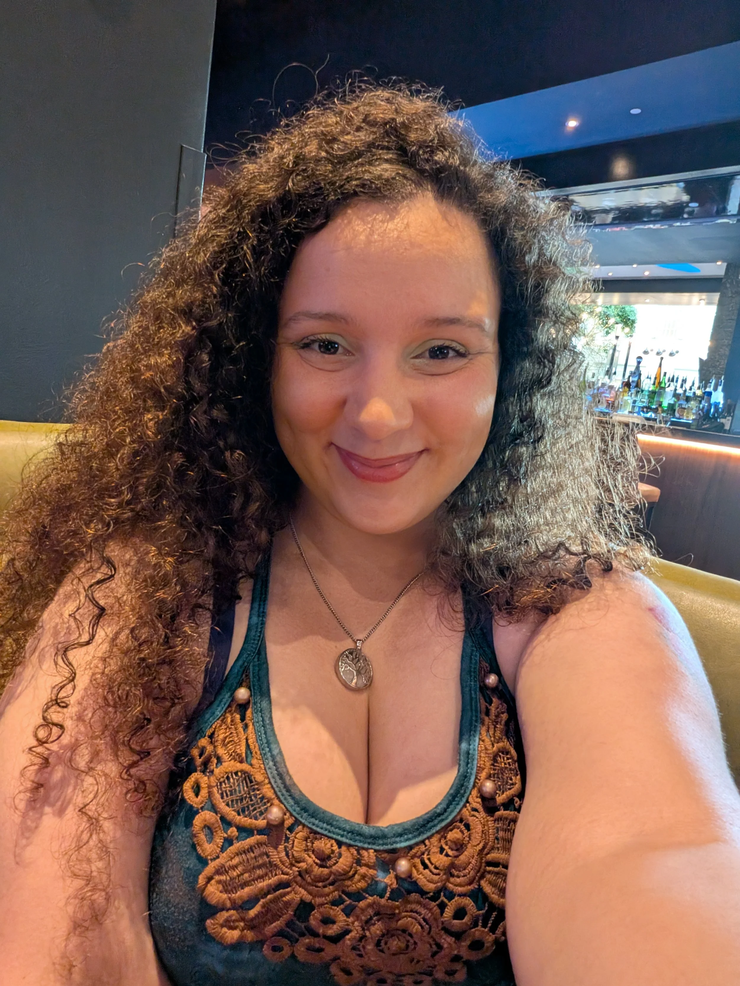 Author Maria Levato sitting at a table as she prepares to meet readers for a book convention.