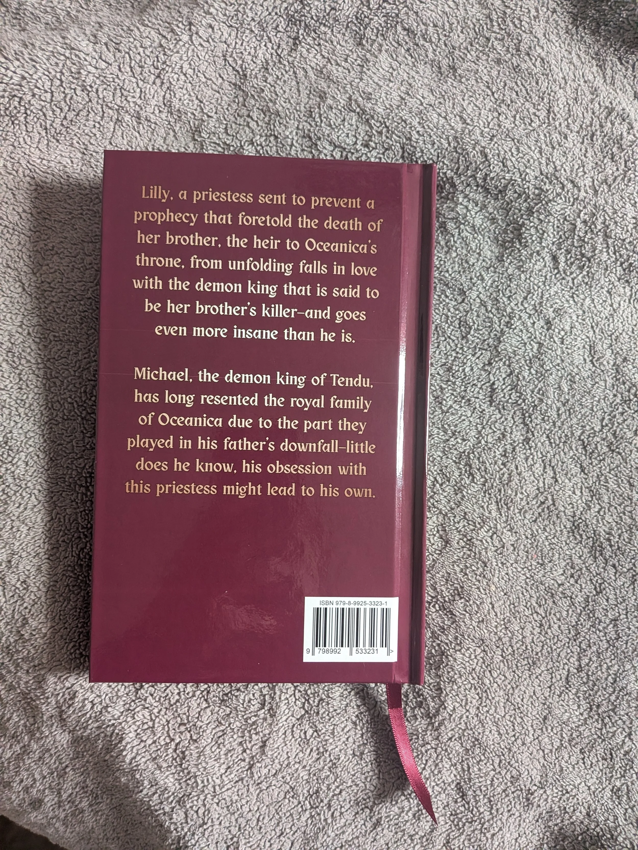 Back cover of a book (The Fate of Angels and Demons by Maria Levato) with a synopsis about Lilly, a priestess, and Michael, the demon king of Tendu. Special Edition Hardcover