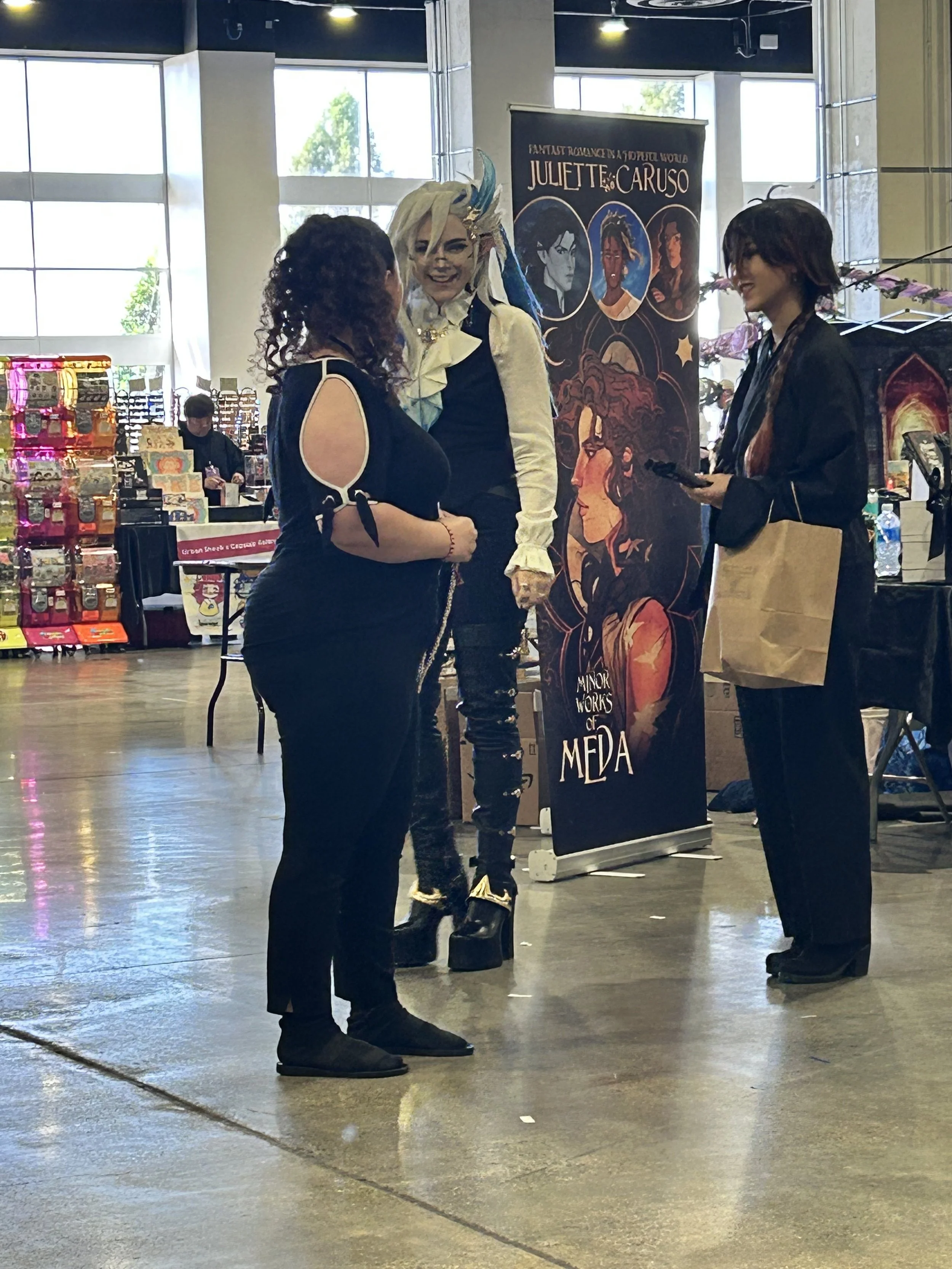 Author Maria Levato talking to Genshin Impact cosplayers