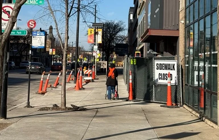 Sidewalk in front of under-construction Timeline Theatre site on Broadway