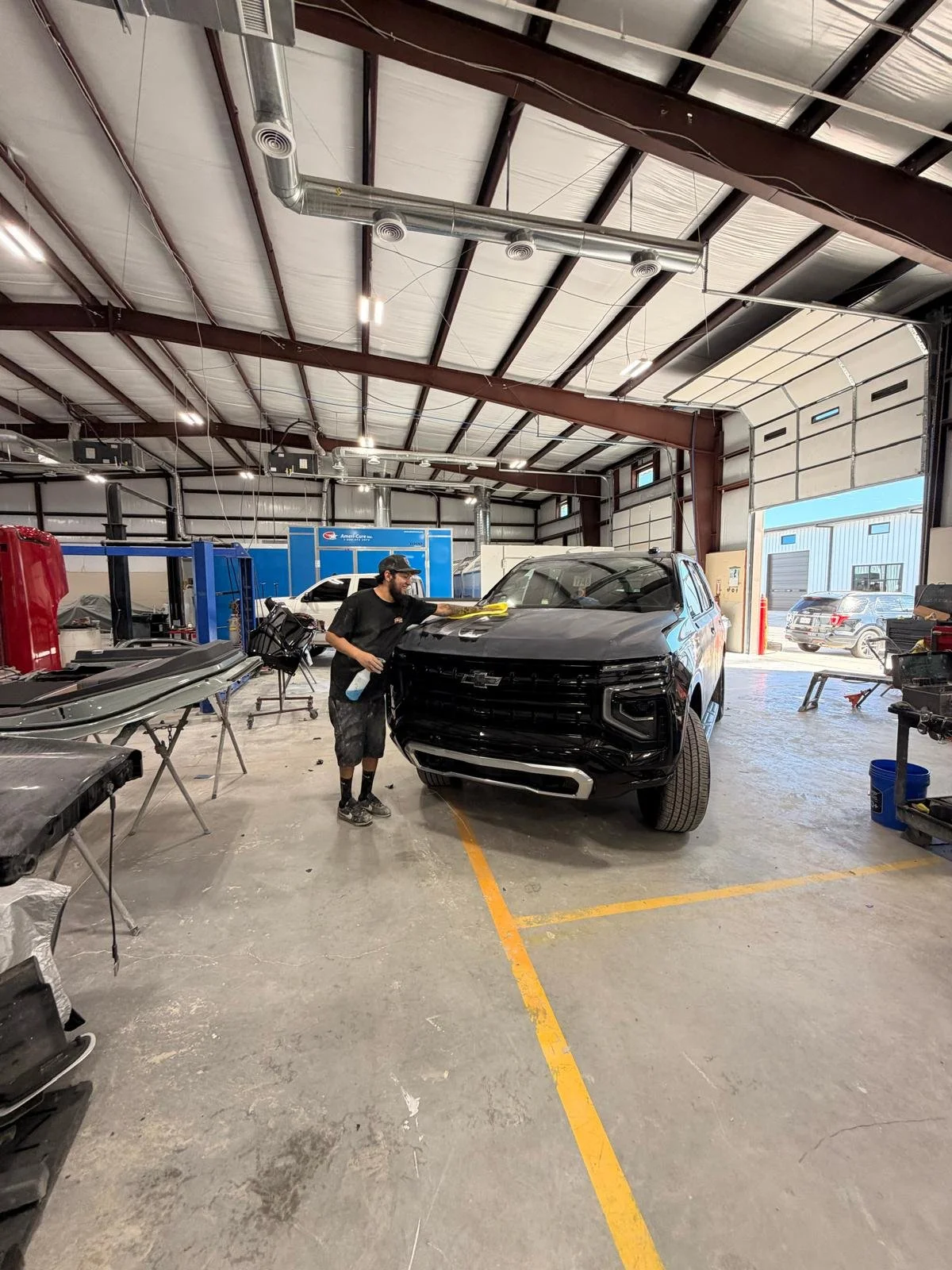 Excellence Auto technician repairing a car after collision.