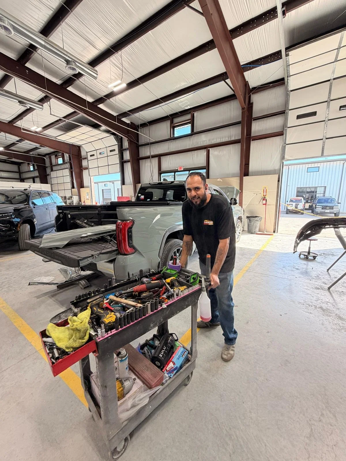 Excellence Auto technician repairing a car after collision.