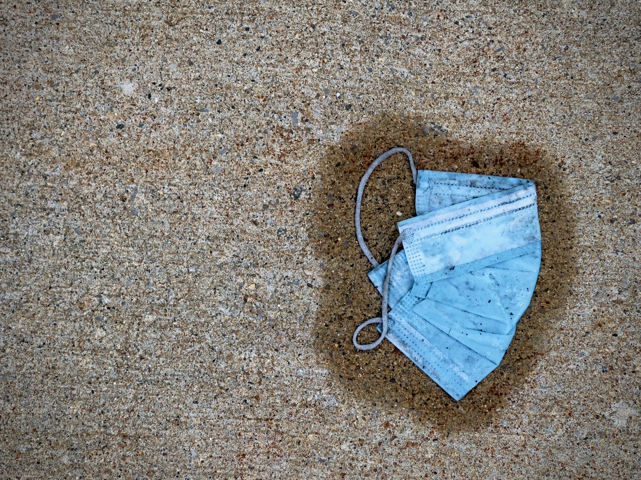 A discarded mask downtown after a rain storm, December 13, 2020.