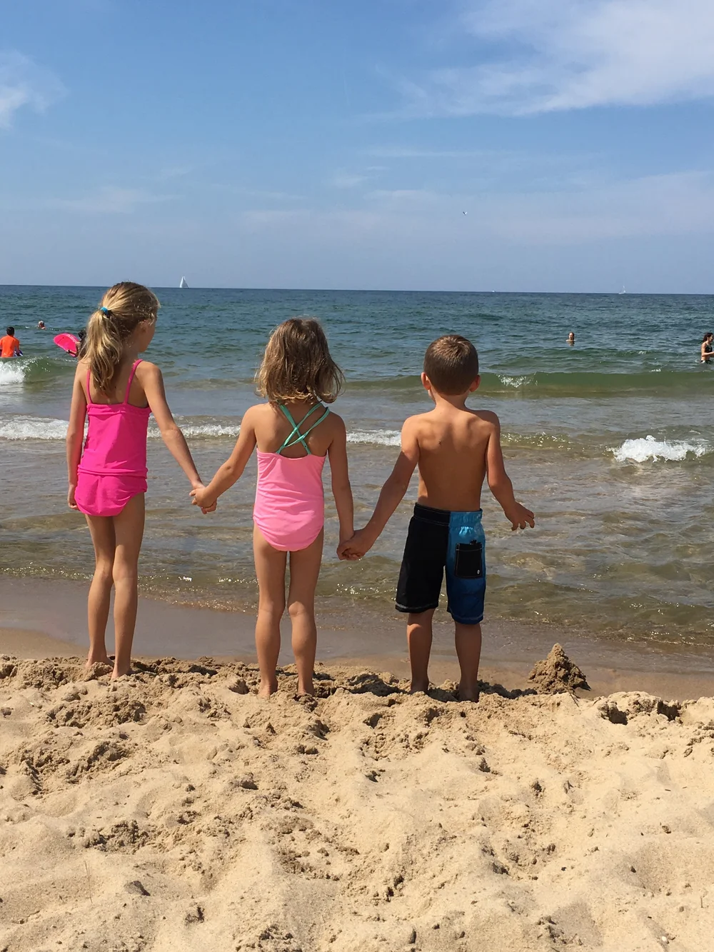 Kids holding hands at Lake Michigan