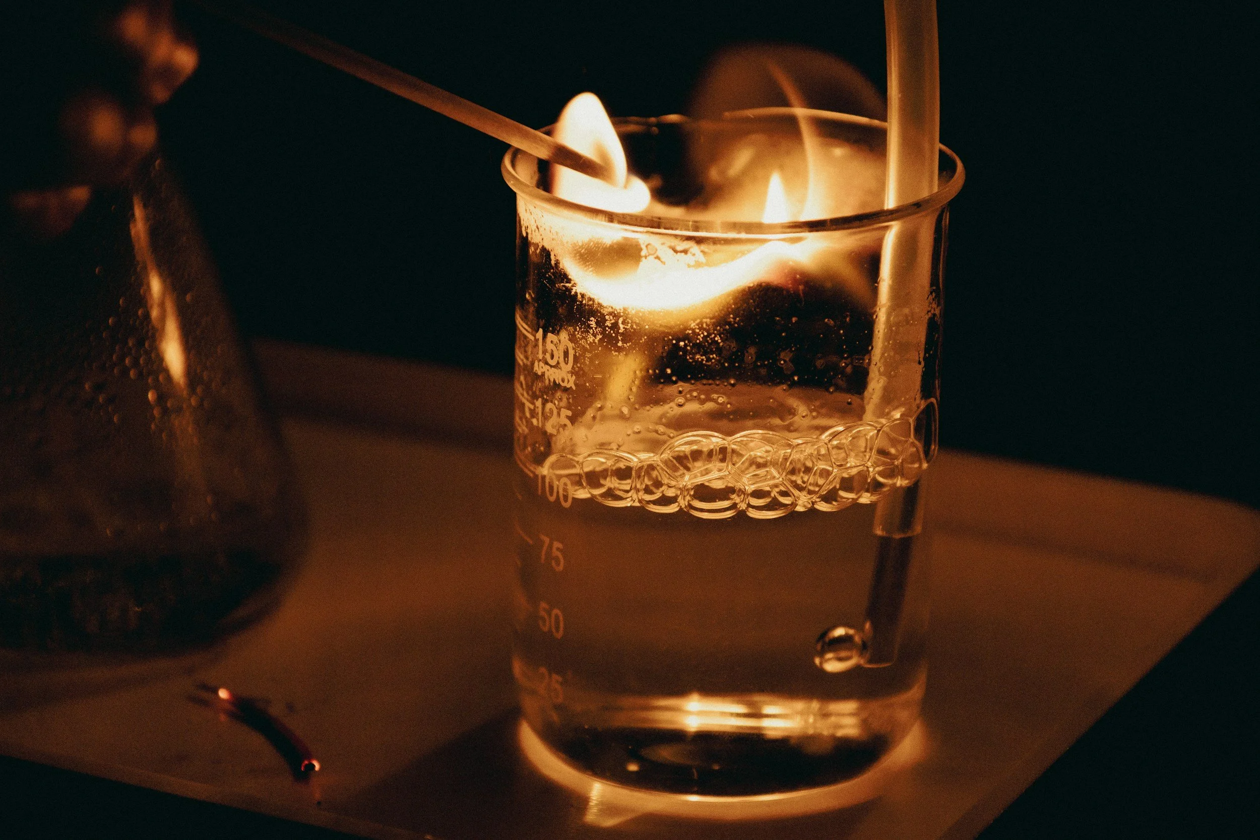 Laboratory beaker with liquid and flame