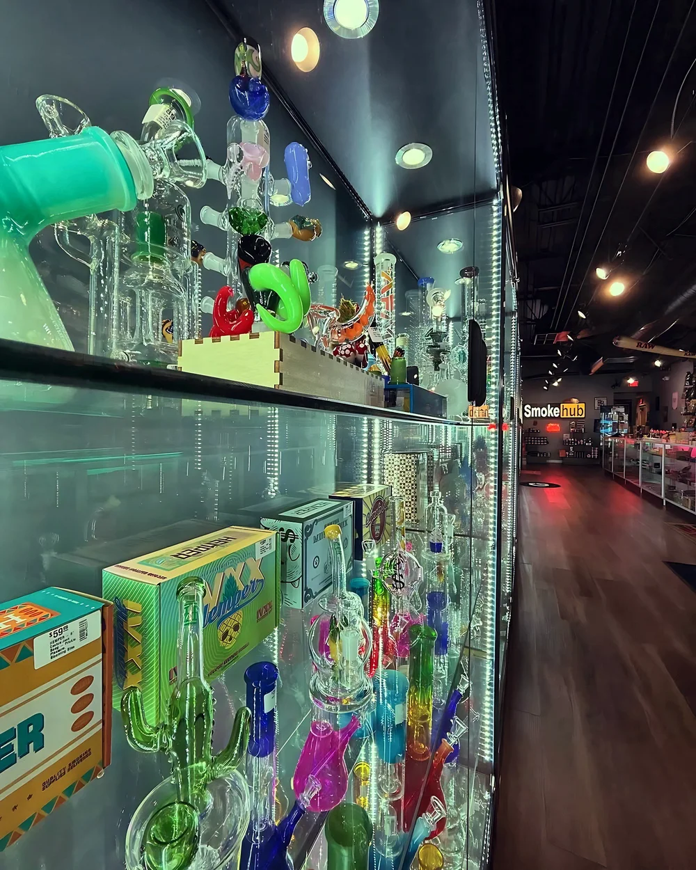 Glass water pipe display wall at Smoke Hub Tinley Park
