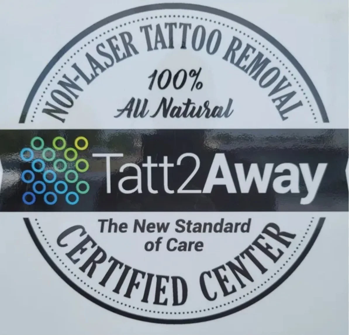 Logo for Tatt2Away, a laser tattoo removal center, with the tagline 'The New Standard of Care'.