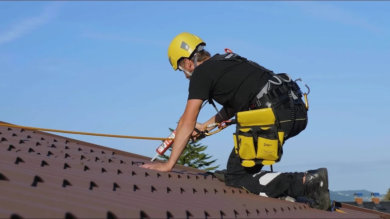 contractor fitting tile seal to orange tile roof
