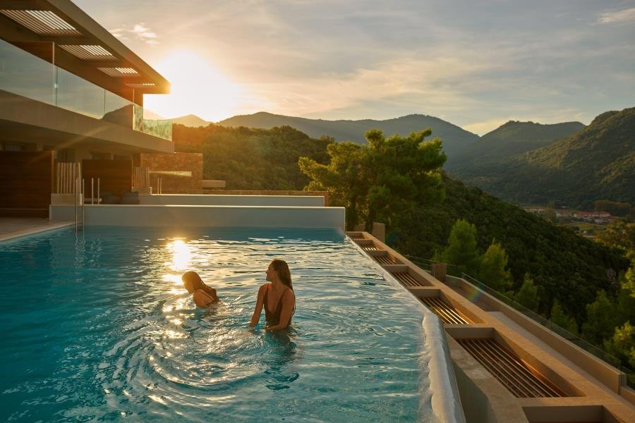 two people in pool, looking over view of Mar-Bella