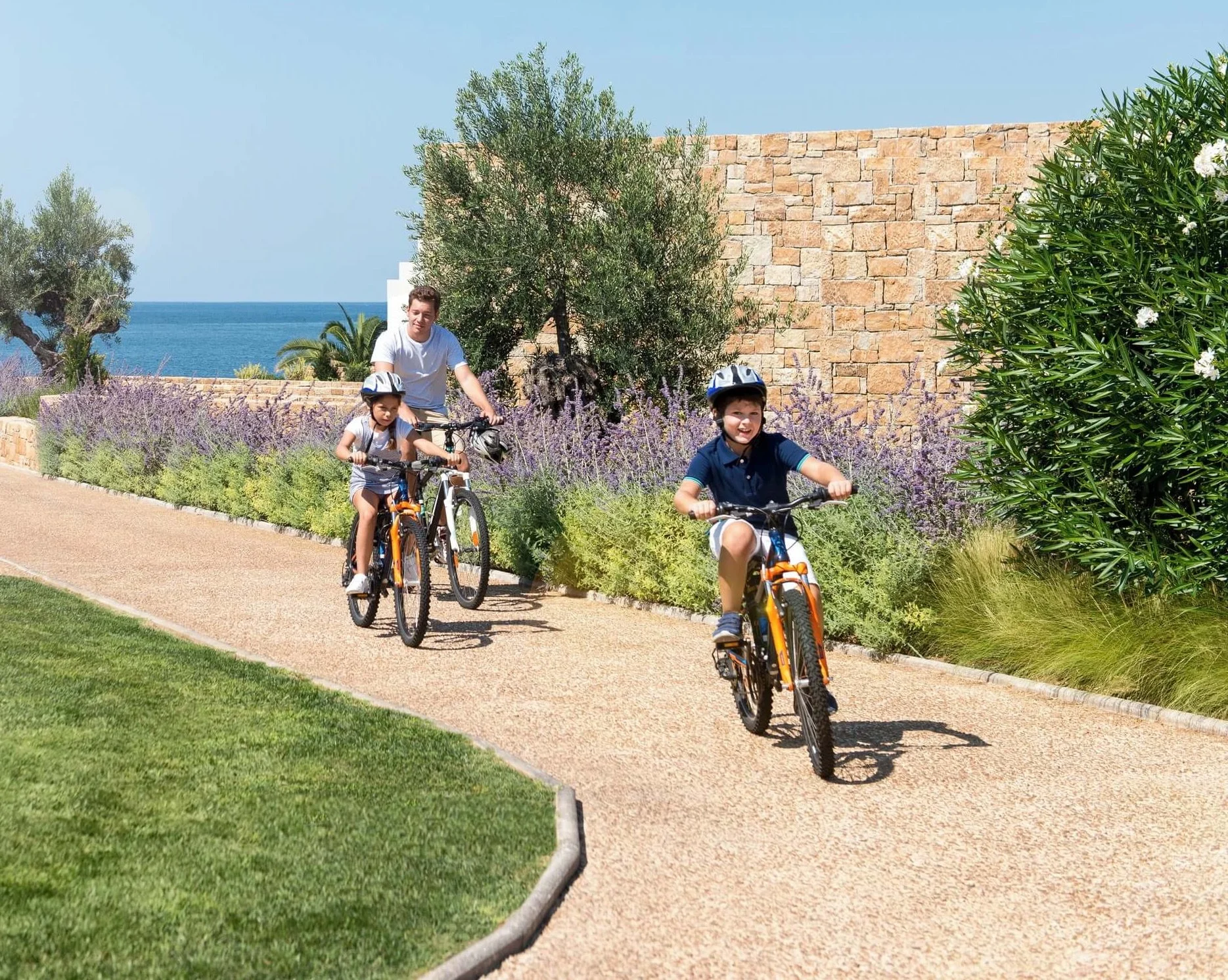 father and two kids on bikes