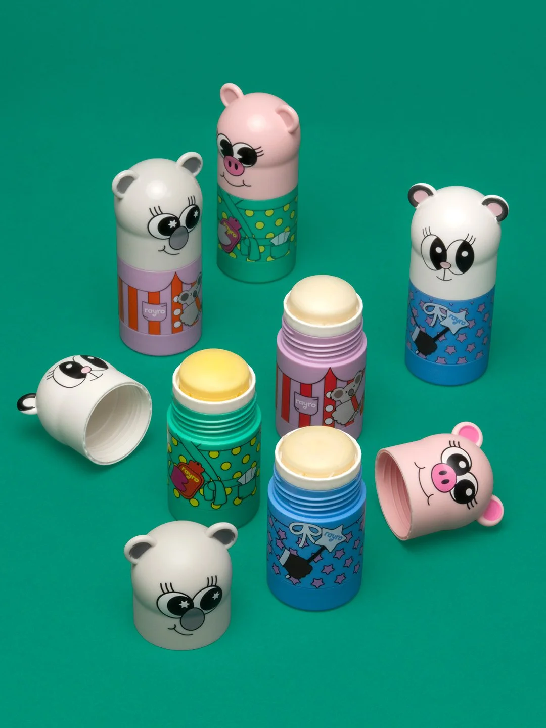 Kids skincare sticks in cute animal packaging, natural balm products for children’s skin, colourful twist-up skincare on green background