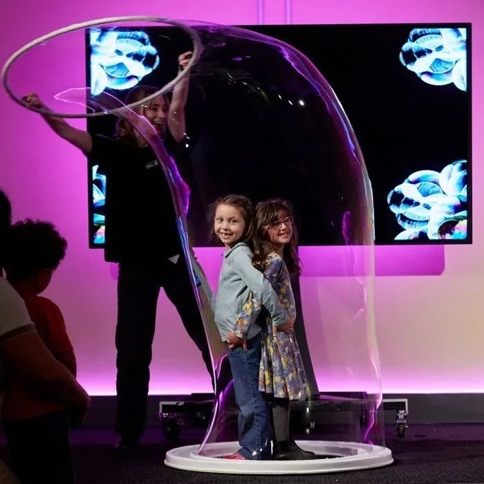 Children enjoying the Bubble Explorers interactive science experience at the Science Museum in London.