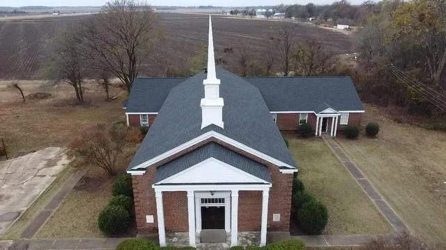 A newly installed shingle roof on a church building