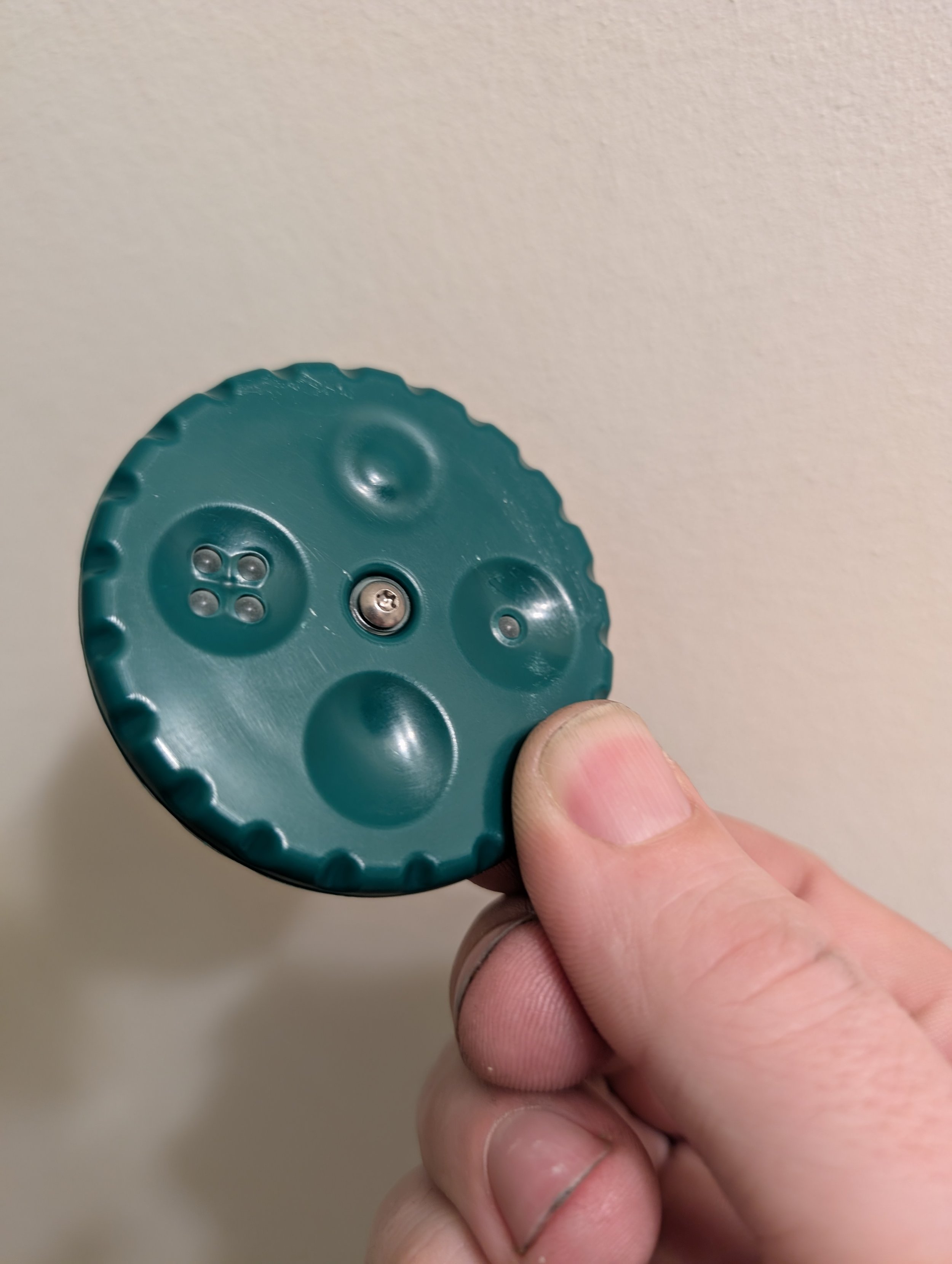 Close up of a person holding a Palm Twirl fidget spinner toy/tool.