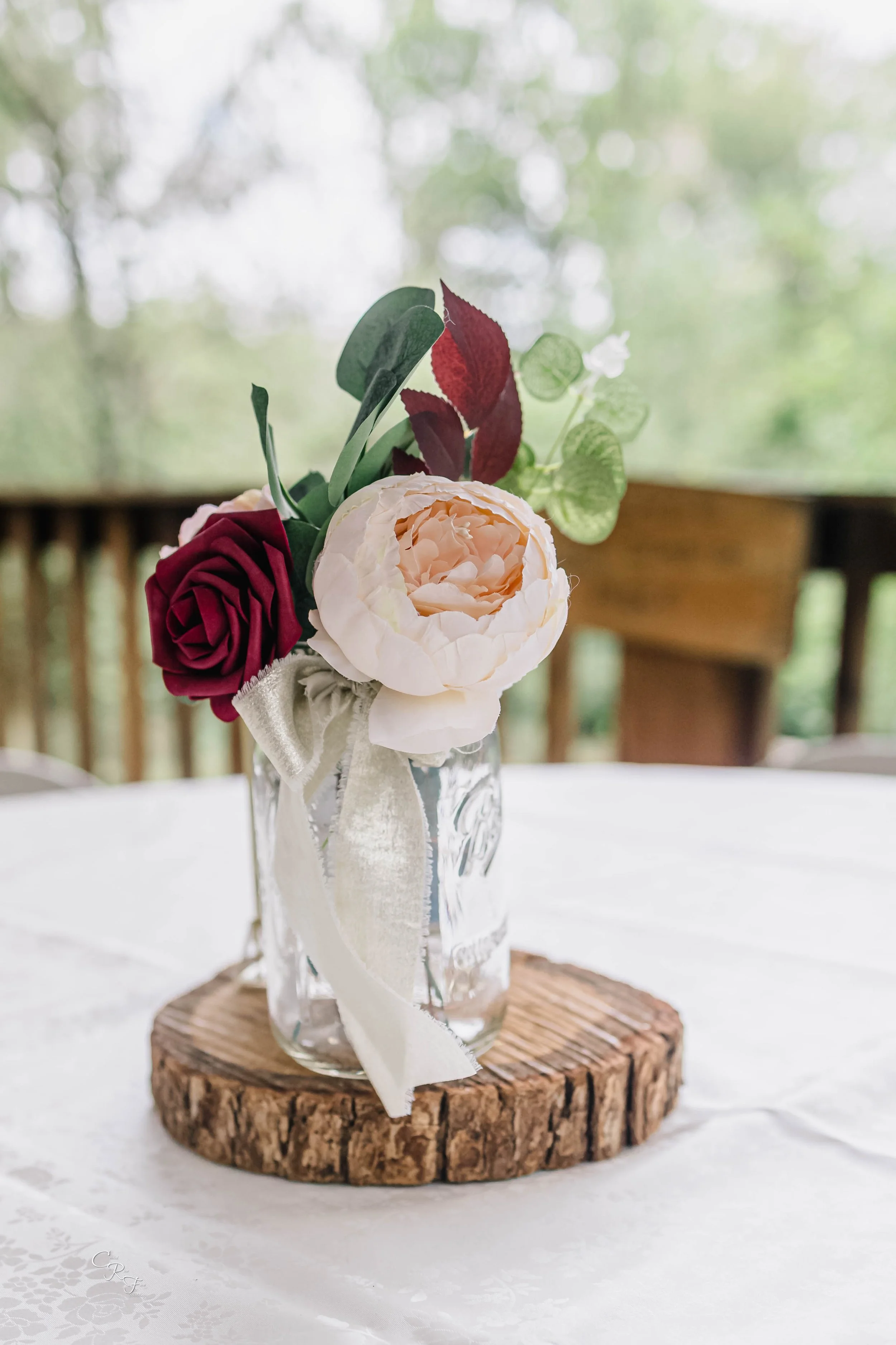 Centerpiece Burgundy wine pink flowers in jar.jpg