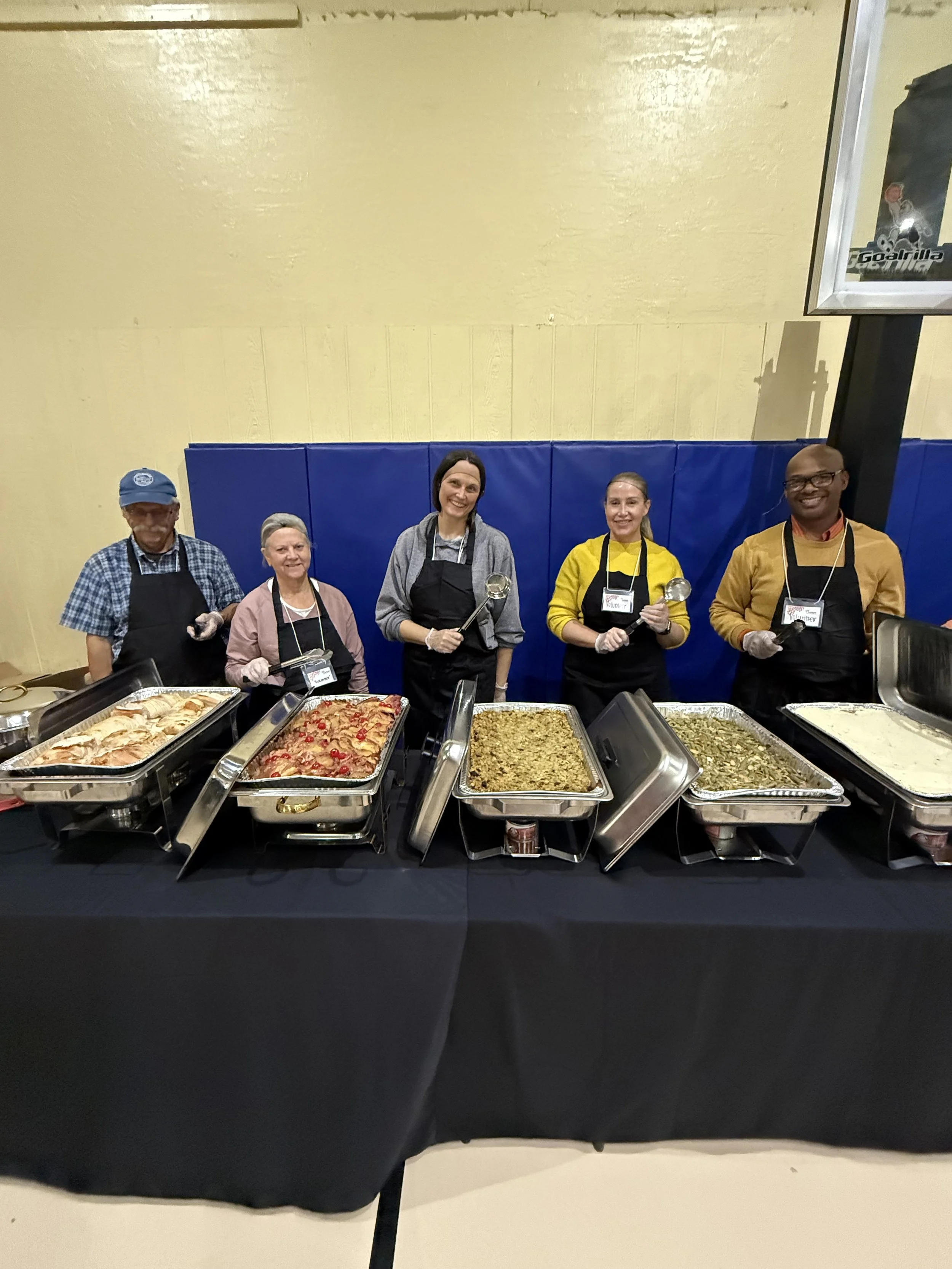 Volunteer preparing to serve food to clients
