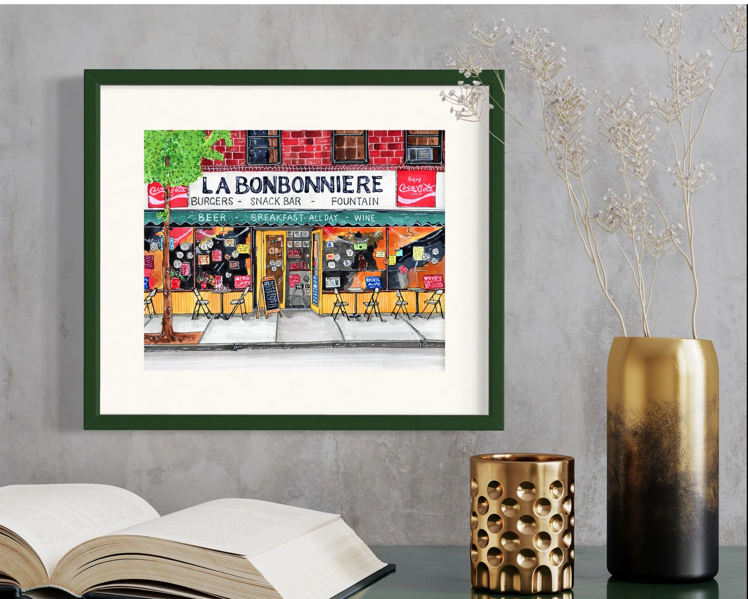 Framed in dark green, this hand-illustrated drawing of La Bonbonniere print hangs on the wall