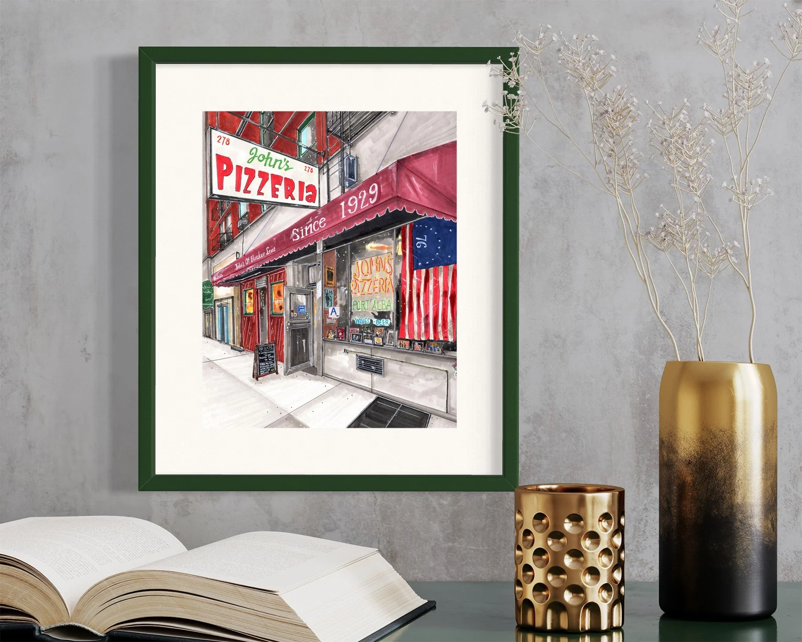 Framed in dark green, this hand-illustrated drawing of John’s Pizzeria print hangs on the wall