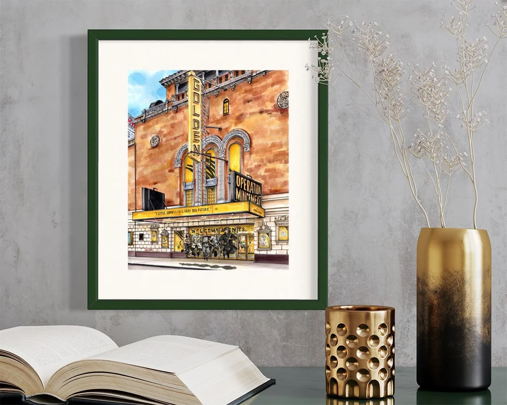 Framed in dark green, this hand-illustrated drawing of Operation Mincemeat the Broadway Musical print hangs on the wall