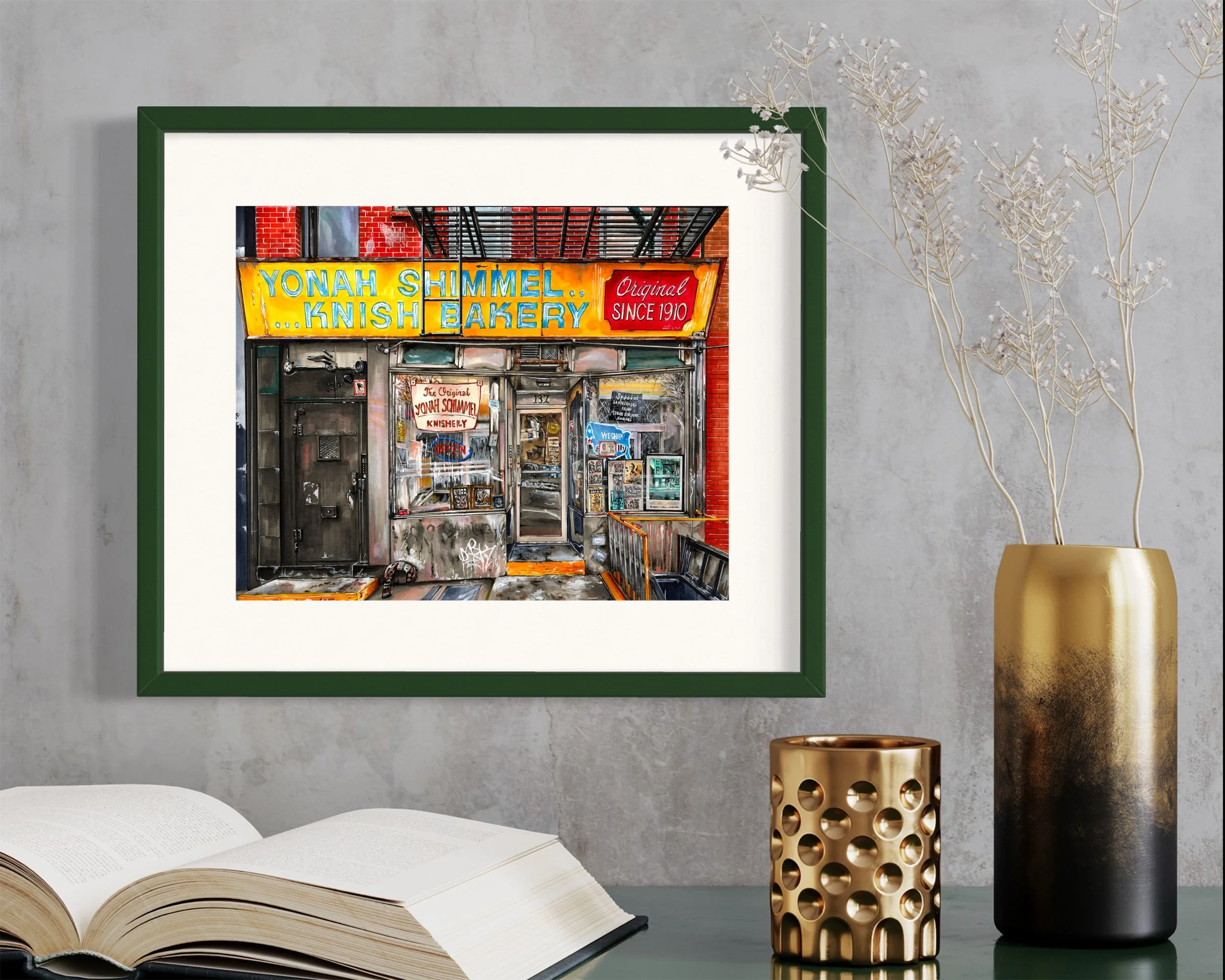 Framed in dark green, this hand-illustrated drawing of Yonah Schimmel Knish Bakery print hangs on the wall