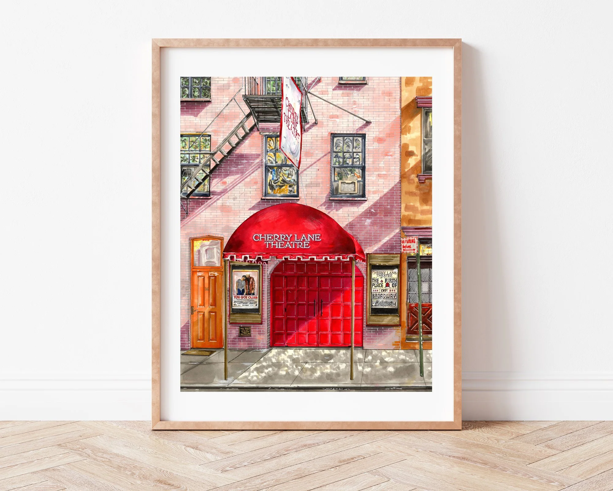 Leaning against a plain wall, Cherry Lane Theatre drawing sits in a slim light wood frame