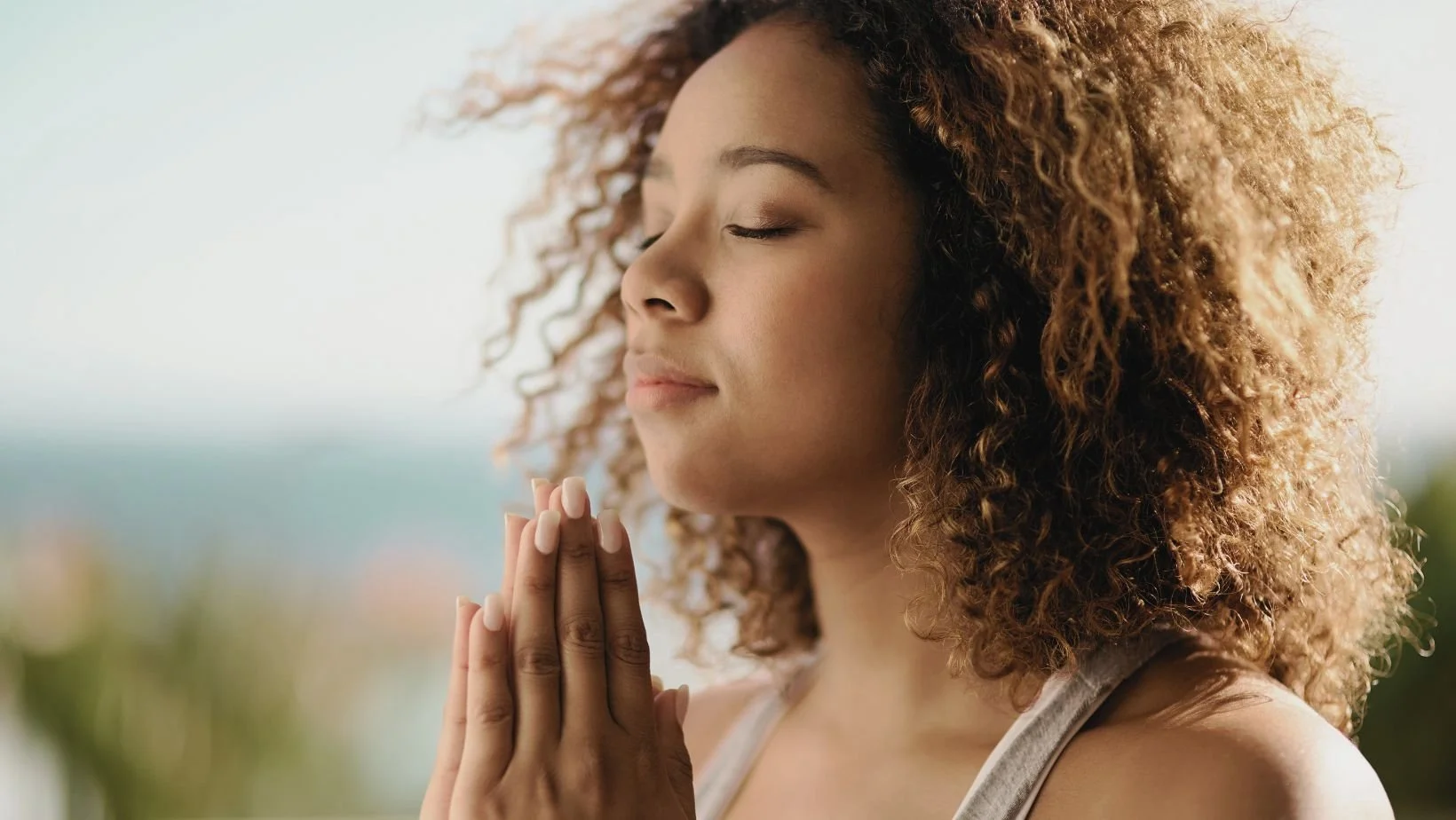 Women giving thanks in pray PowerfulME human optimisation and health programs
