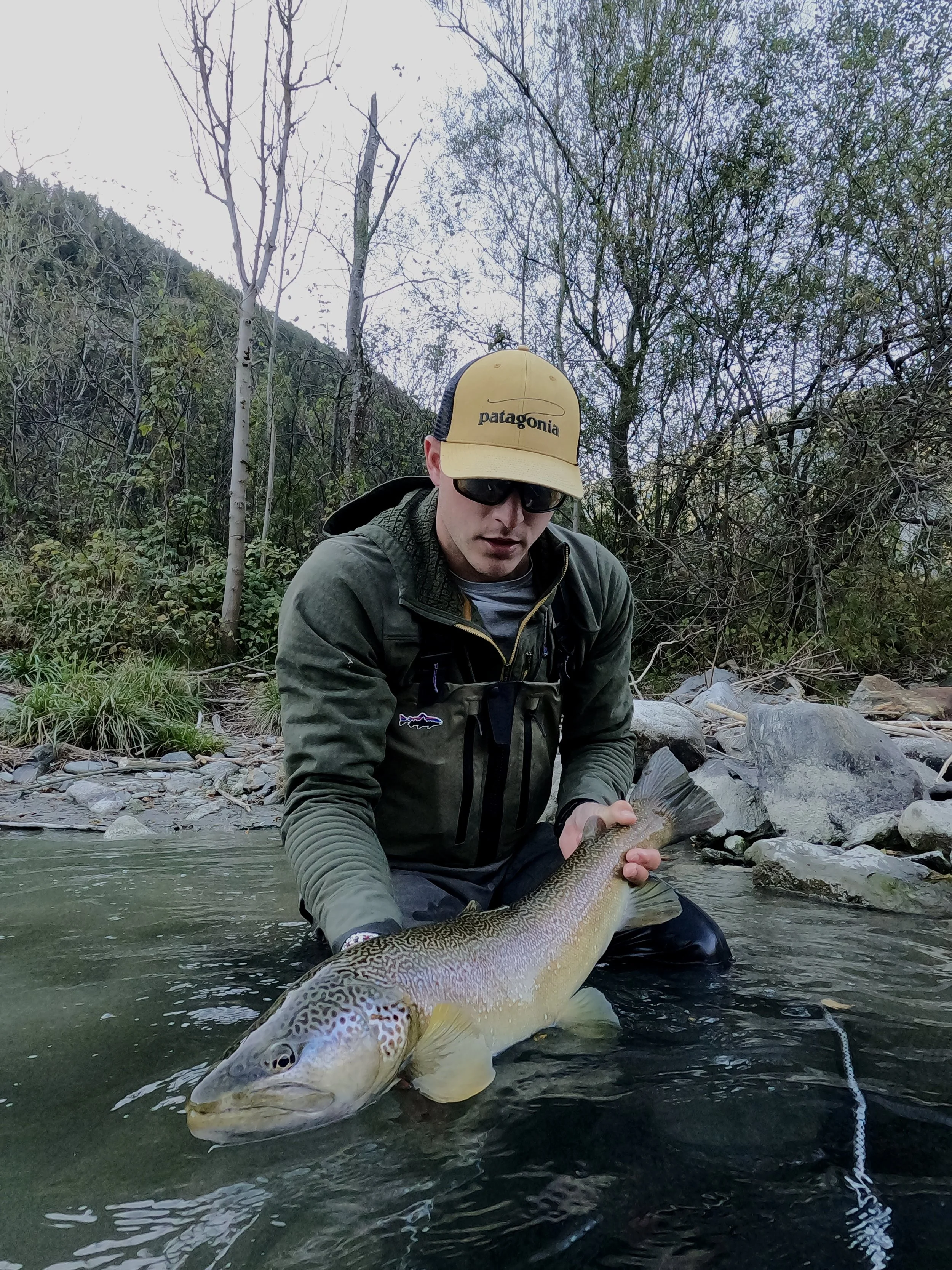 Stefano Fedrizzi with a huge marble trout in the trentino dolomites, get the chance to fish with one of the best guide in Italy