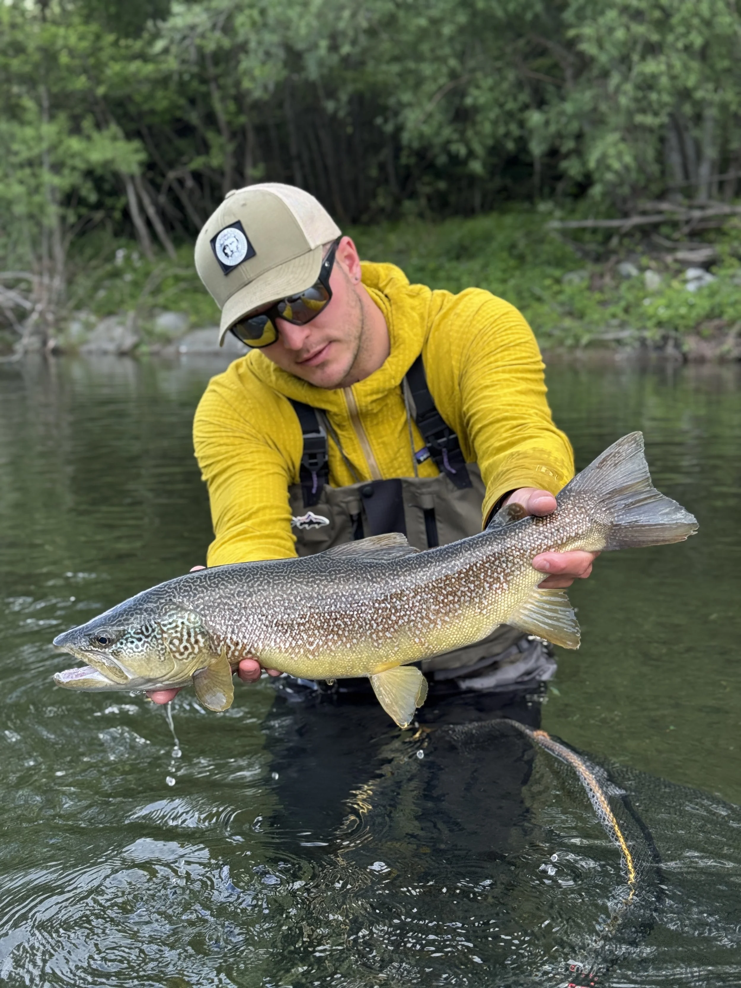 Stefano Fedrizzi, expert fishing guide in northern Italy holding a stunning marble trout